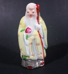 Vintage Chinese God Shou Wiseman in a Yellow Robe with Red Staff holding Fruit Ceramic Figurine - Treasure Valley Antiques & Collectibles