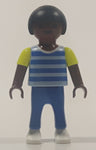 1995 Geobra Playmobil Small Black Haired Boy Child Blue Pants Two Tone Blue and Fluorescent Green Sleeved Shirt 2 1/8" Tall Toy Figure
