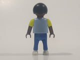 1995 Geobra Playmobil Small Black Haired Boy Child Blue Pants Two Tone Blue and Fluorescent Green Sleeved Shirt 2 1/8" Tall Toy Figure