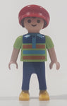 1995 Geobra Playmobil Small Brunette Boy Child Blue Pants Orange and Blue Striped Green Shirt Red Cap 2 1/8" Tall Toy Figure
