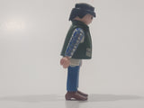 1994 Geobra Playmobil Black Hair Blue Pants White Blue and Grey Plaid Shirt with Olive Green Vest 2 3/4" Tall Toy Figure