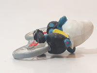 Vintage 1979 Peyo Smurfs Smurf Riding Bicycle 2 5/8" Long PVC Toy Figure