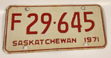 Vintage 1971 Saskatchewan Farm Vehicle Red Lettering White Vehicle License Plate Metal Tag 29 645