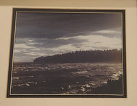 Waves Washing Ashore on a Beach with Two People in the Corner Black and White Purple Tinge Photograph in Frame