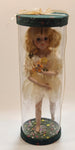 Girl Holding Butterfly in Green Grass Flower Meadow 10" Tall Porcelain Doll In Plastic Tube Display Case