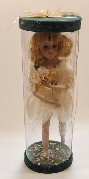 Girl Holding Butterfly in Green Grass Flower Meadow 10" Tall Porcelain Doll In Plastic Tube Display Case