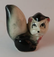 Vintage Girl Eye Lashed Skunk with Pink Bow Figurine Looking Upwards - Treasure Valley Antiques & Collectibles