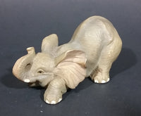 Elephant Figurine Laying Down with Trunk Upwards Marked ©97 WUI - Treasure Valley Antiques & Collectibles