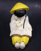 Vintage Chalkware Asian Child in Yellow Hat Sitting and Reading a Book Figurine - Treasure Valley Antiques & Collectibles