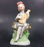Vintage Victorian Girl Sitting on a Fence Playing a Mandolin Ceramic Figurine - Treasure Valley Antiques & Collectibles