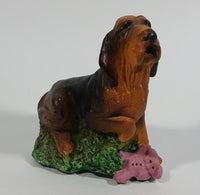 Vintage 1981 Dark Brown Hound Dog Holding Down a Pink Teddy Bear on Grass Collectible Figurine Numbered #714