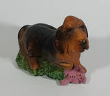 Vintage 1981 Dark Brown Hound Dog Holding Down a Pink Teddy Bear on Grass Collectible Figurine Numbered #714
