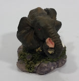 Elephant with Tusks Pulling a Log With It's Trunk Resin Figurine - SABRE - Treasure Valley Antiques & Collectibles