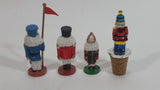 Three Small Christmas Nutcracker Figures and One Bottle Cork Nutcracker