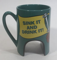 1998 Warner Bros Looney Tunes Taz Tasmanian Devil Cartoon Character "Sink It and Drink It!" Dark Green Ceramic Coffee Mug with Hole For Golf Ball Underneath