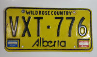 Vintage 1980s Alberta Wild Rose Country Yellow with Black Letters Passenger Vehicle Metal License Plate Tag VXT - 776