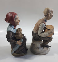 Old Man Sitting With Keg Barrel and Beer Stein and Old Woman Sitting with Umbrella and Packages Porcelain Figurines Set of 2