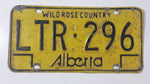 Vintage 1975 to 1984 Alberta Wild Rose Country Black Lettering Yellow Vehicle License Plate Metal Tag LTR 296