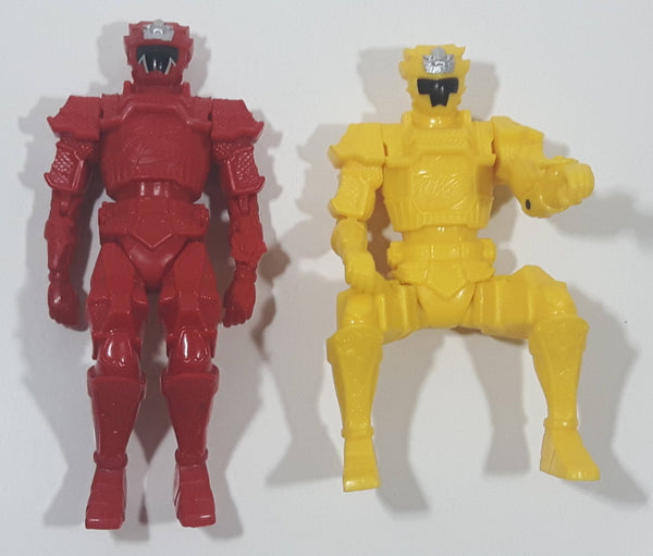 Red and Yellow Toy Action Figures in Seated Like Riding Positions