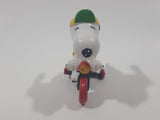 Vintage United Feature Peanuts Snoopy Learning To Ride A Bike On Bicycle With Training Wheels 2 1/2" Tall PVC Toy Figure Made in Hong Kong