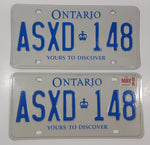 Matching Set of 2 Ontario Yours To Discover White with Blue Letters Vehicle License Plate ASXD 148