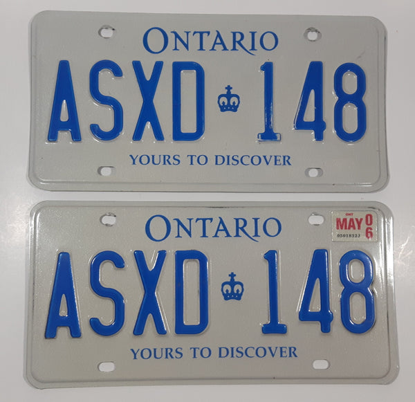 Matching Set of 2 Ontario Yours To Discover White with Blue Letters Vehicle License Plate ASXD 148