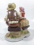 Vintage Man and Woman Sitting Holding Flowers 6 1/4" Tall Porcelain Figurine