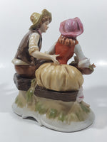 Vintage Man and Woman Sitting Holding Flowers 6 1/4" Tall Porcelain Figurine