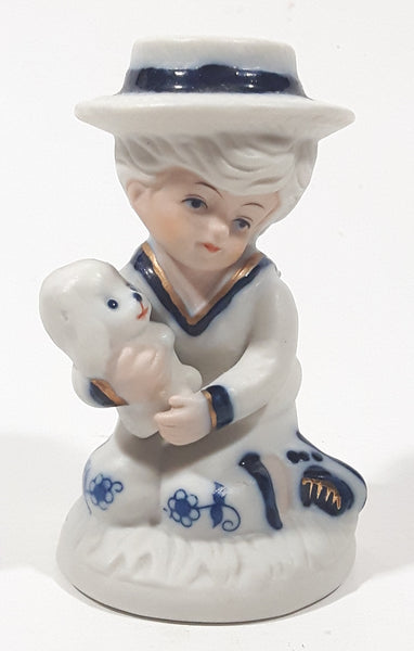 Vintage Brinns Blue and White French Colonial Boy Holding White Puppy Dog 4" Tall Porcelain Figurine