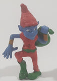 Blue Skinned Elf Wearing Red and Green Clothes Sneakily Carrying Bag While Walking On Tip Toes 2 1/2" Tall Toy Figure