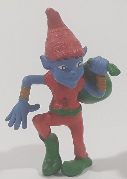 Blue Skinned Elf Wearing Red and Green Clothes Sneakily Carrying Bag While Walking On Tip Toes 2 1/2" Tall Toy Figure