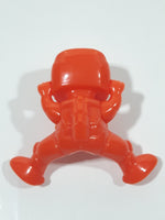 Orange Character with Helmet In Riding Pose With Arms Up 1 7/8" Tall Plastic Toy Figure