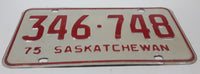 Vintage 1975 Saskatchewan Red Lettering White Vehicle License Plate Metal Tag 346 748