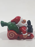 Santa Claus On His Sled with Bag of Presents 2 5/8" Long Toy Figure