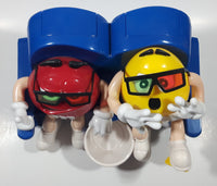 1999 M & M's Red And Yellow Character Sitting In Movie Theater Chairs Eating Popcorn Wearing 3D Glasses Plastic Candy Dispenser Machine