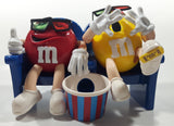 1999 M & M's Red And Yellow Character Sitting In Movie Theater Chairs Eating Popcorn Wearing 3D Glasses Plastic Candy Dispenser Machine