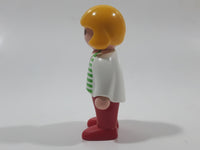 1990 Geobra Playmobil Girl with Blond Hair in White Shirt with Green Striped Sweater and Red Pants 2 1/4" Tall Toy Figure