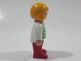 1990 Geobra Playmobil Girl with Blond Hair in White Shirt with Green Striped Sweater and Red Pants 2 1/4" Tall Toy Figure