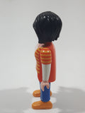 1992 Geobra Playmobil Woman with Black Hair Orange and Yellow Striped Sweater Over White Top and Blue Jean Pants 3" Tall Toy Figure