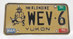 1989 1990 Yukon The Klondike Man Panning Gold Themed Yellow Metal Vehicle License Plate Tag WEV 6