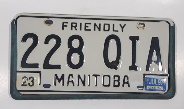 1997 Friendly Manitoba White With Black Letters Metal Vehicle License Plate Tag 228 QIA in Blue Cluthe Frame Holder